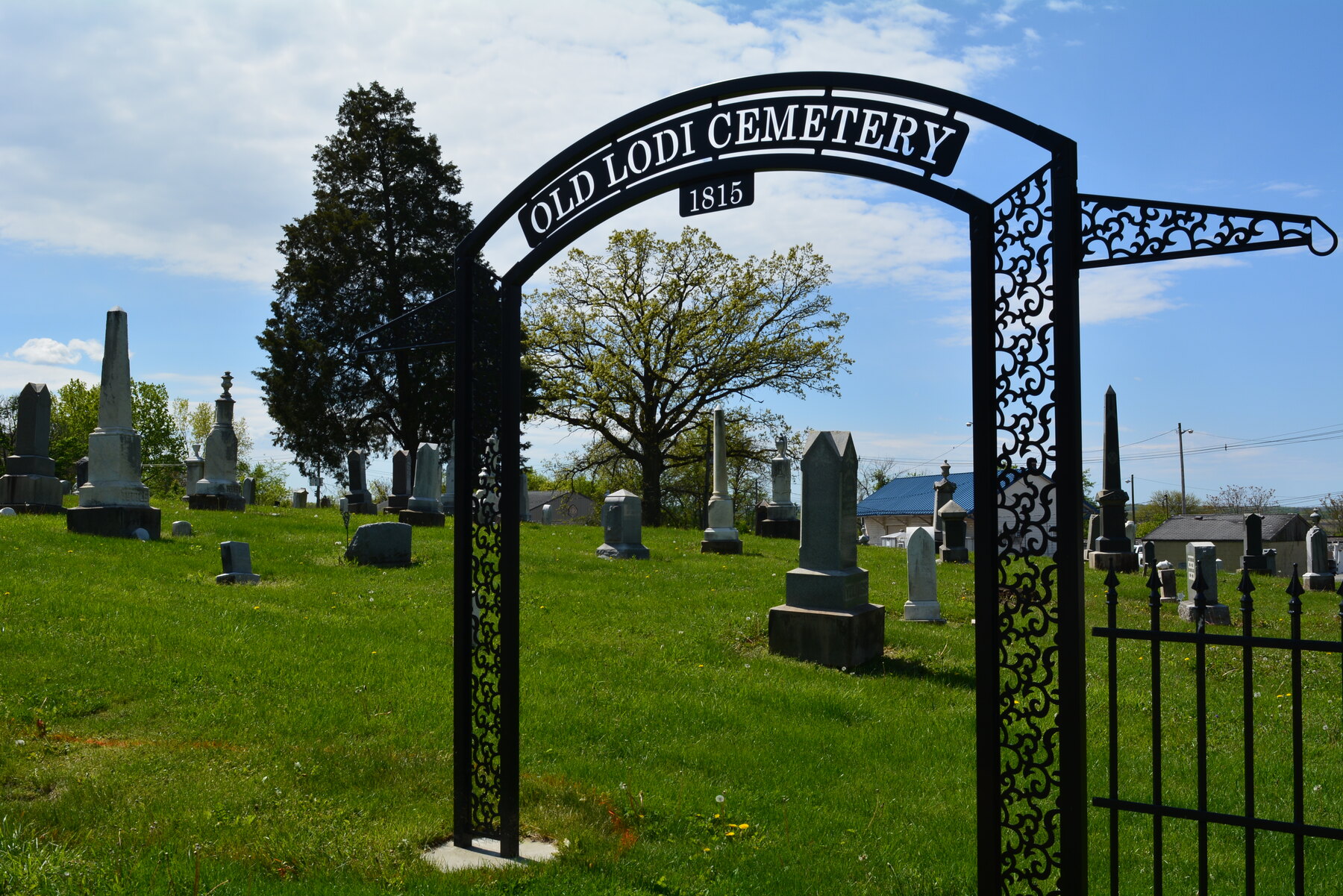 The arched Old Lodi Cemetery entrance gate overlooking historic headstones